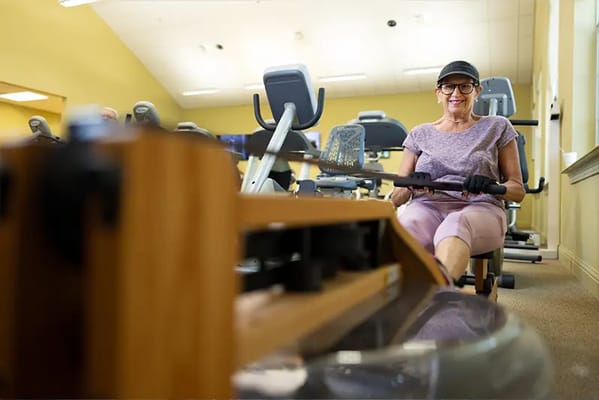 Resident engaging in exercise on rowing machine