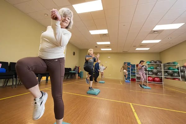 Residents participating in a fitness class in a studio