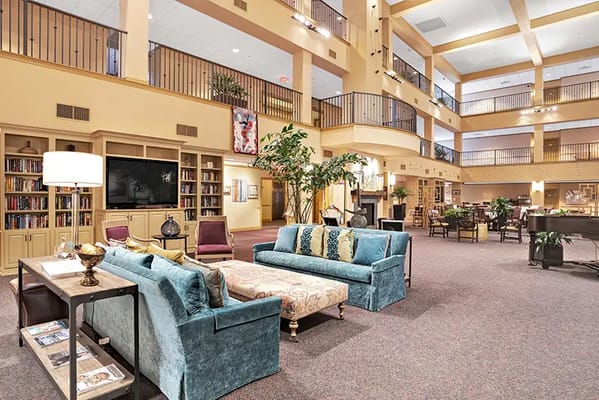 Bright and spacious common area with seating and bookshelves