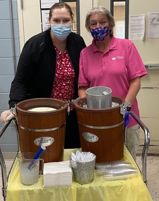Staff serving ice cream to residents