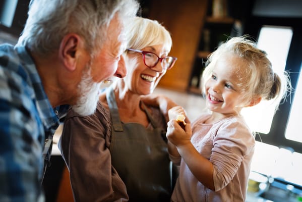 Elderly couple interacting joyfully with a child