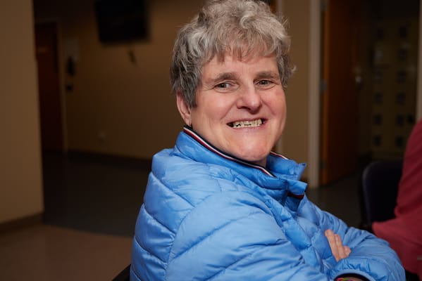 A smiling resident in a common area of the facility