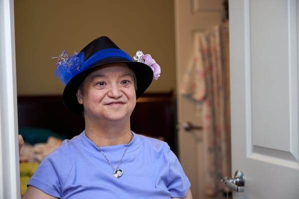 Resident smiling while wearing a decorative hat
