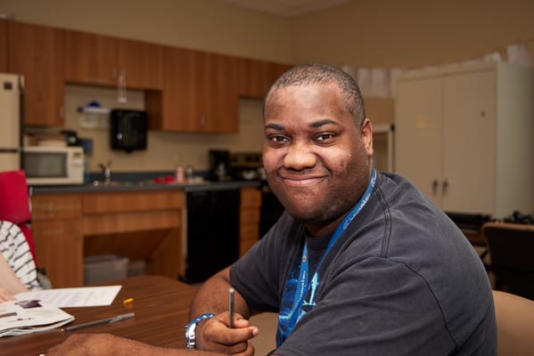 Resident smiling in a facility common area