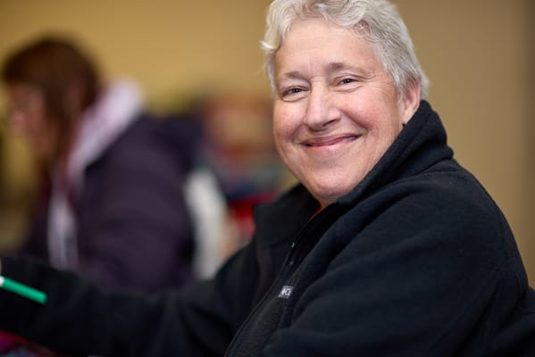 Smiling resident in a warm indoor setting