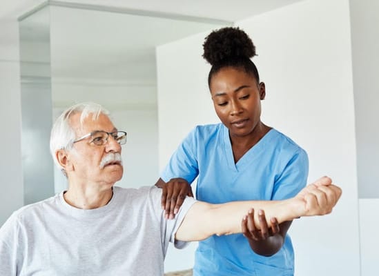 Nurse assisting a senior resident with physical therapy