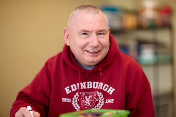 Resident smiling while engaged in an activity