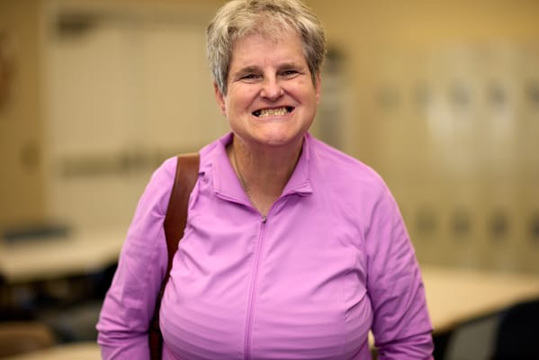 A resident smiling in a common area