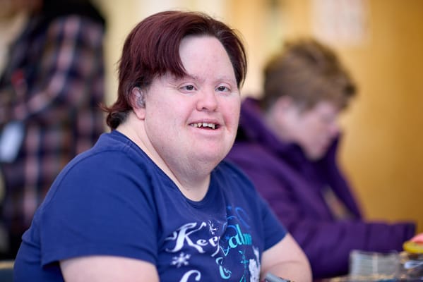 Resident smiling during an activity indoors