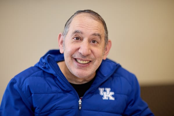 Smiling resident wearing a blue jacket