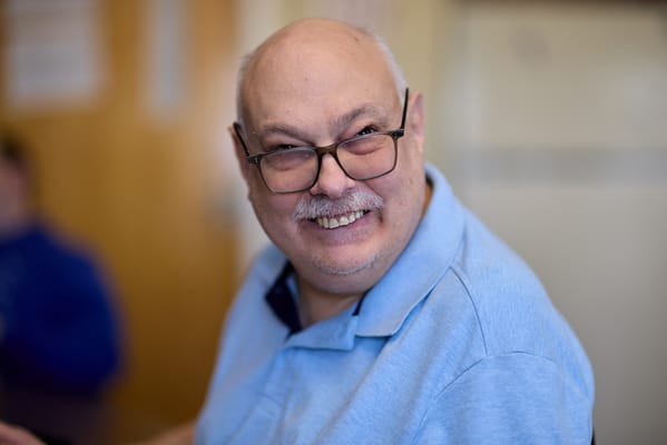 Senior man smiling in a bright room