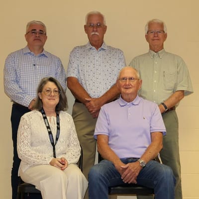 Five residents and staff members posing together