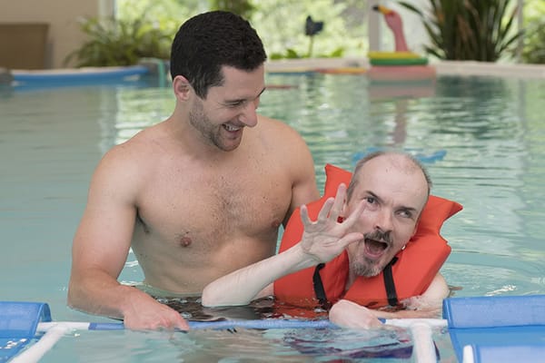 Therapist assisting a resident in a therapeutic pool