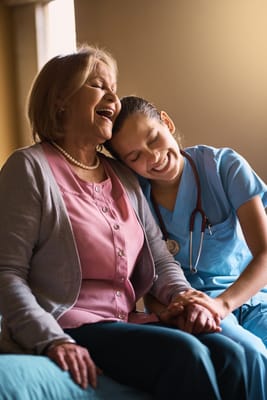 A caregiver and resident sharing a joyful moment