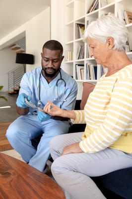 Healthcare worker checking vitals of a senior woman