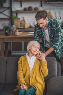 A caregiver with a senior woman in a cozy living space