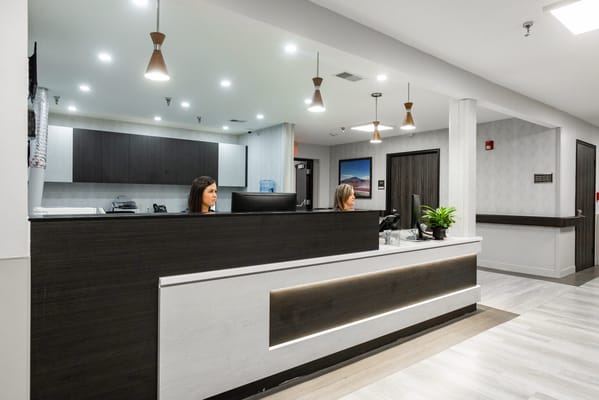 Reception area with staff attending to visitors