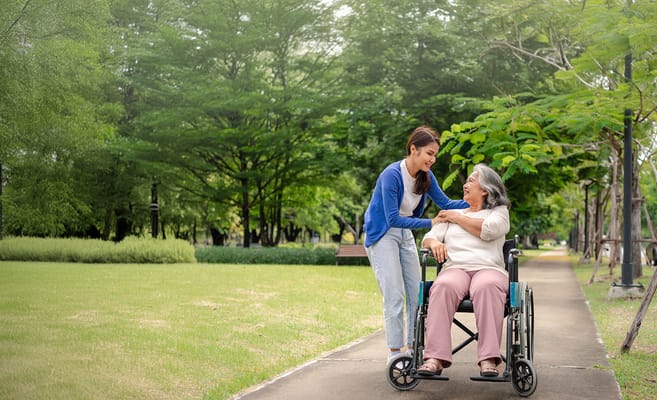 Caregiver assisting a resident in a park