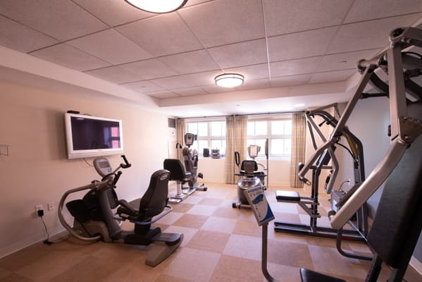 Fitness area with exercise equipment and large windows