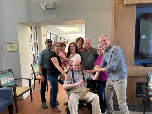 Group of residents and staff celebrating in the common area