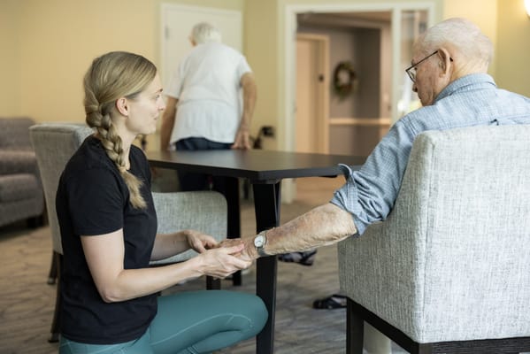 Caregiver interacting with a resident in a common area