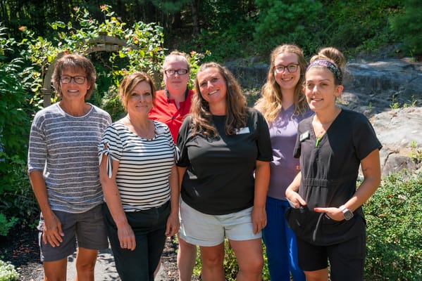Staff members posing in the garden area of the facility