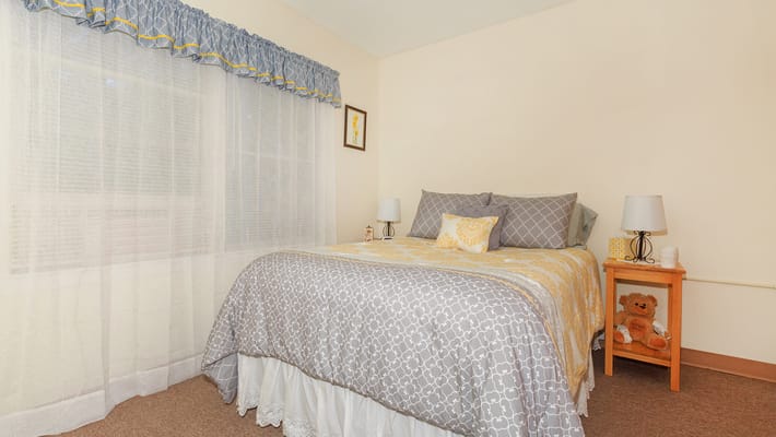 Private resident room with a bed and window