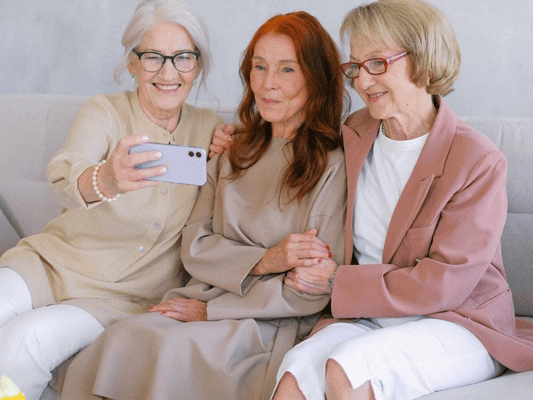 Three residents smiling together while taking a selfie