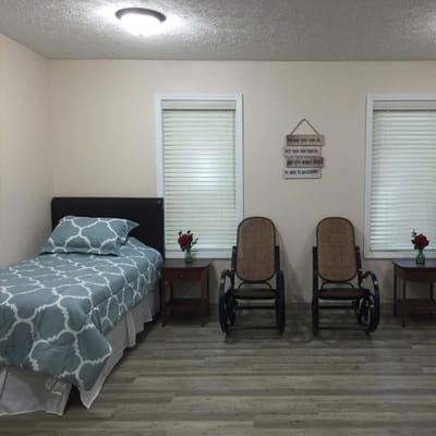 Private resident room with a bed and seating area