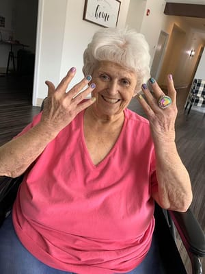 A resident showing off decorated nails in a community area