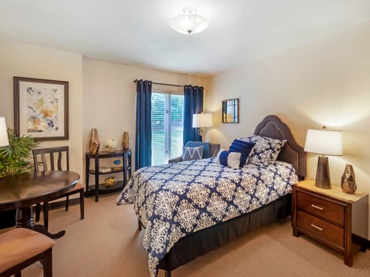 Cozy resident room with a bed and dining table