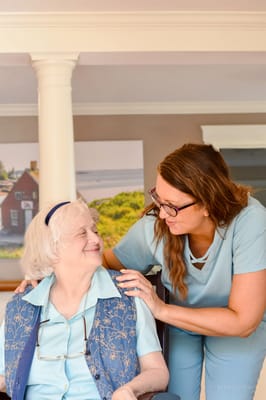 Senior resident and staff member interacting in a common area