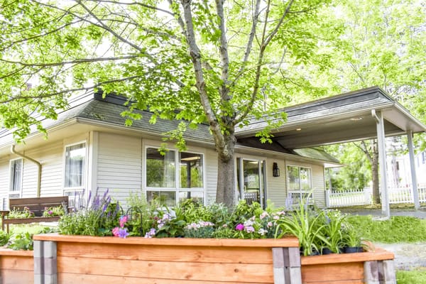 Exterior view of a care facility with gardens