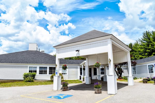 Exterior view of Bella Point Bridgton with flower pots