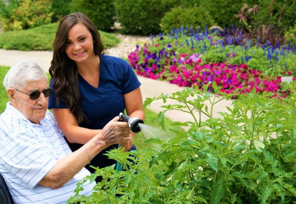 Resident watering plants in a beautiful garden