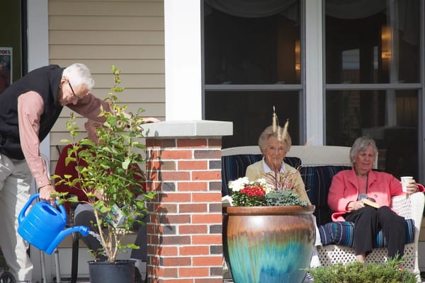 Residents enjoying time on the porch with plants
