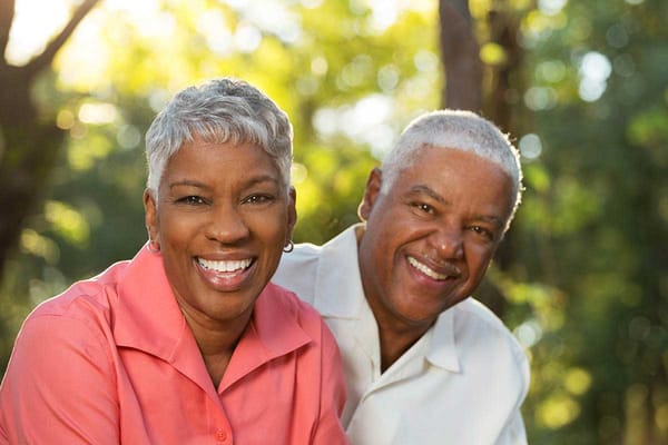 Smiling elderly couple outdoors in a natural setting