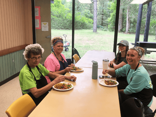 Staff and residents enjoying a meal in the dining room
