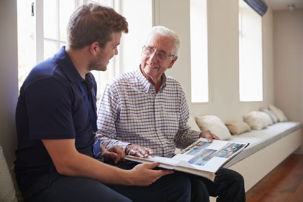 Staff member showing photo album to a resident