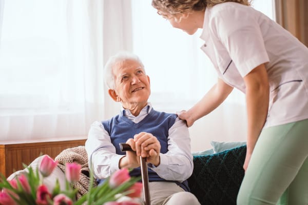 A caregiver interacting with a cheerful elderly resident