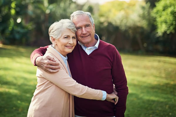 Senior couple embracing in a garden