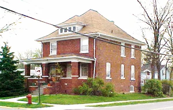 Exterior view of a brick house with porch