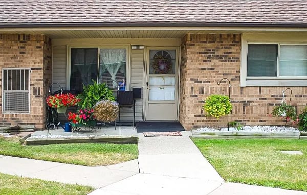 Front entrance of a senior living facility with flowers
