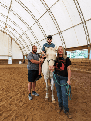 Residents participating in therapeutic horseback riding