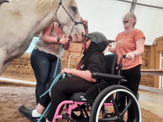 Residents engaging with a horse during therapy