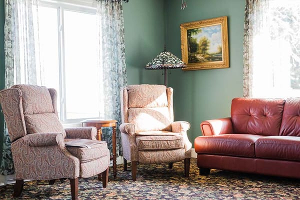Cozy sitting area with comfortable chairs and a lamp