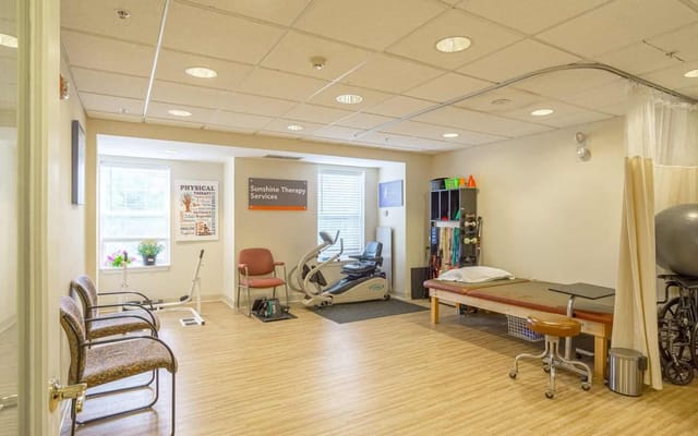 Therapy room with exercise equipment and seating