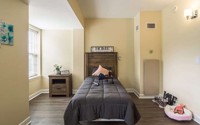 Private room with a bed and nightstand