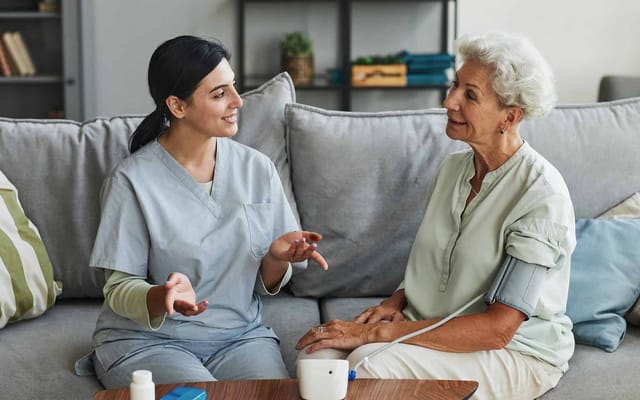 A caregiver interacting with a resident in a comfortable setting