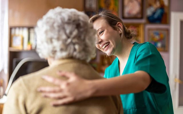 Caregiver interacting warmly with a resident